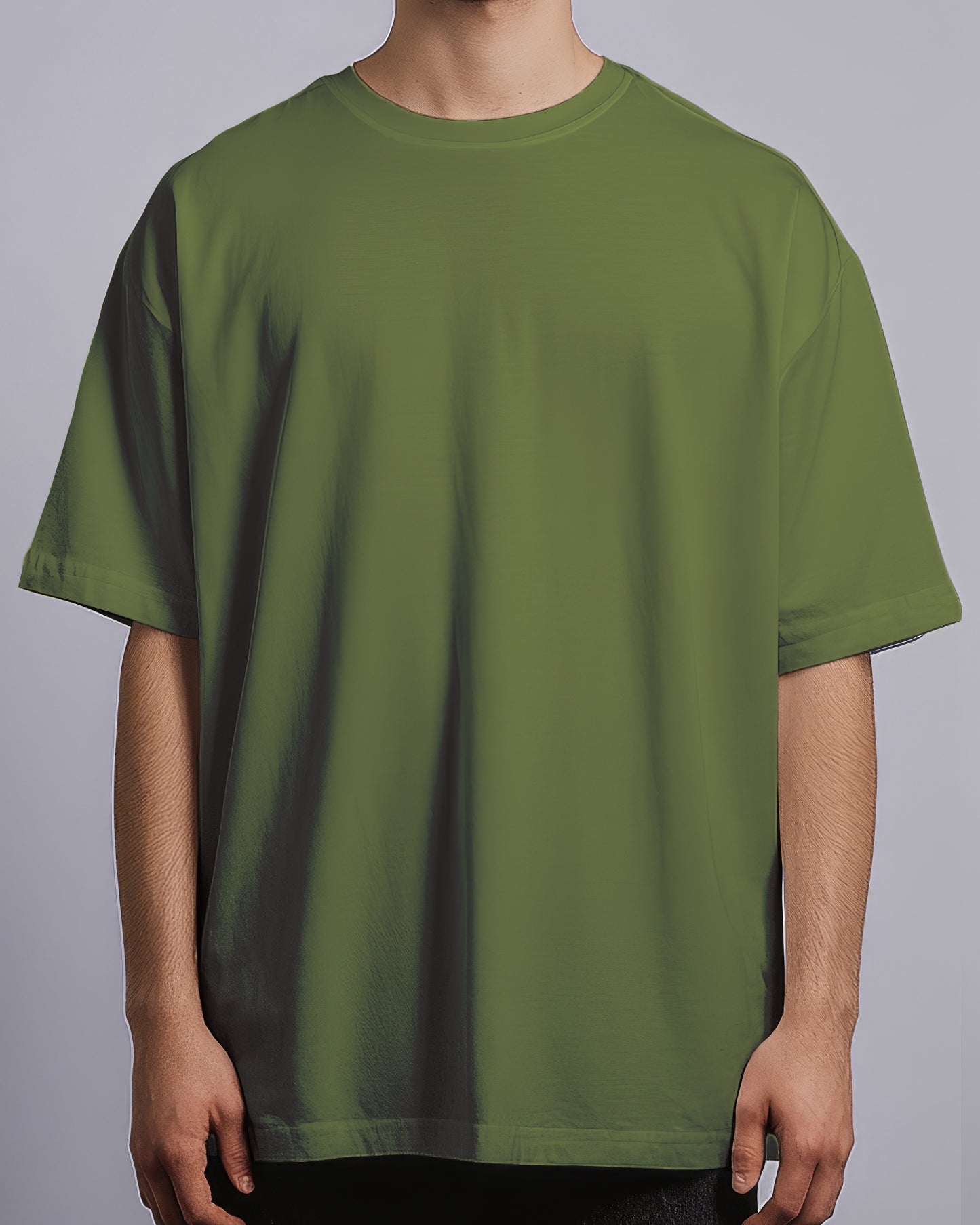 Green t-shirt worn by a person on a gray background