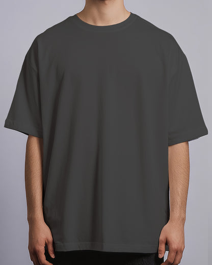 Person wearing a plain dark gray t-shirt on a light gray background