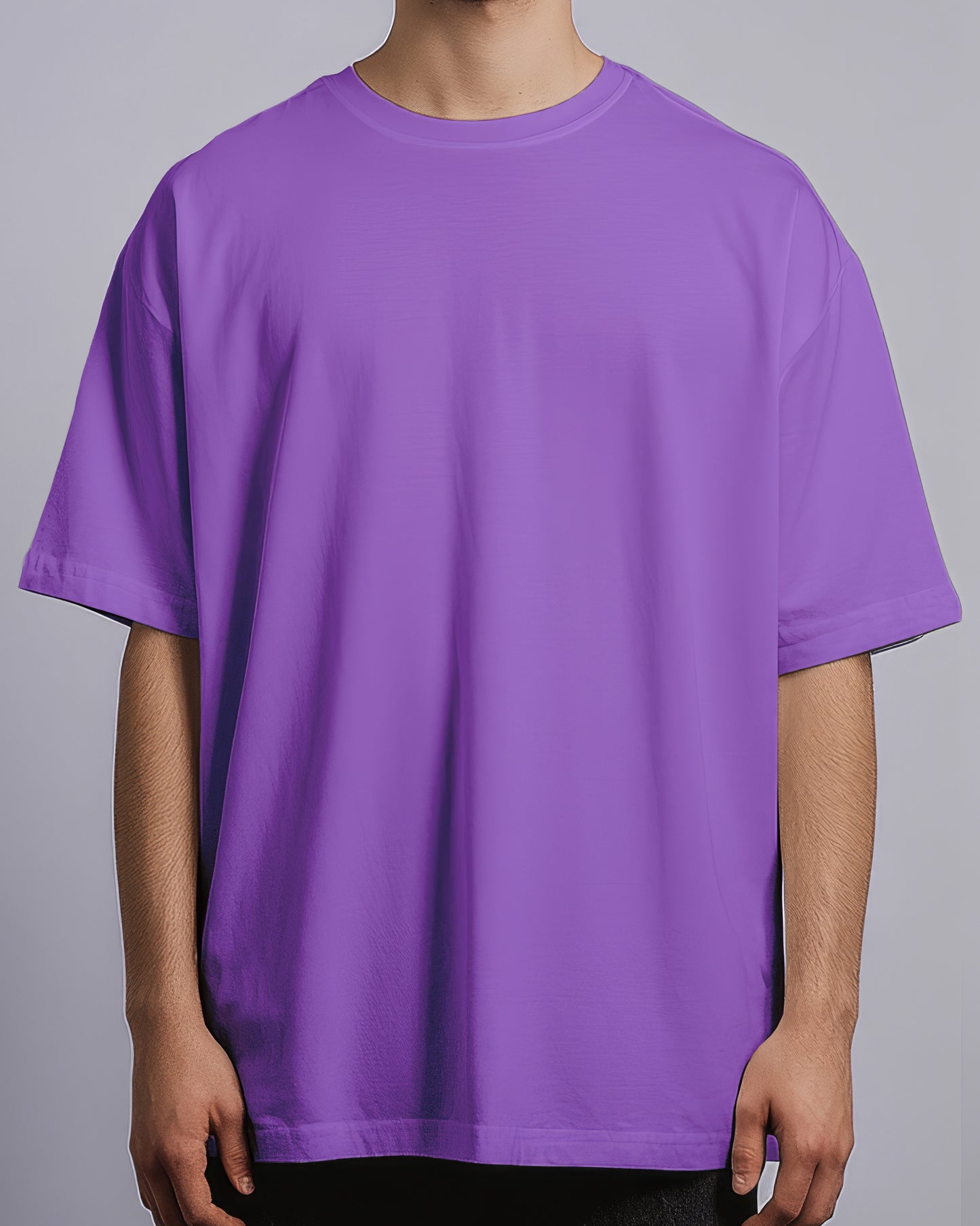 Person wearing a plain purple t-shirt against a gray background