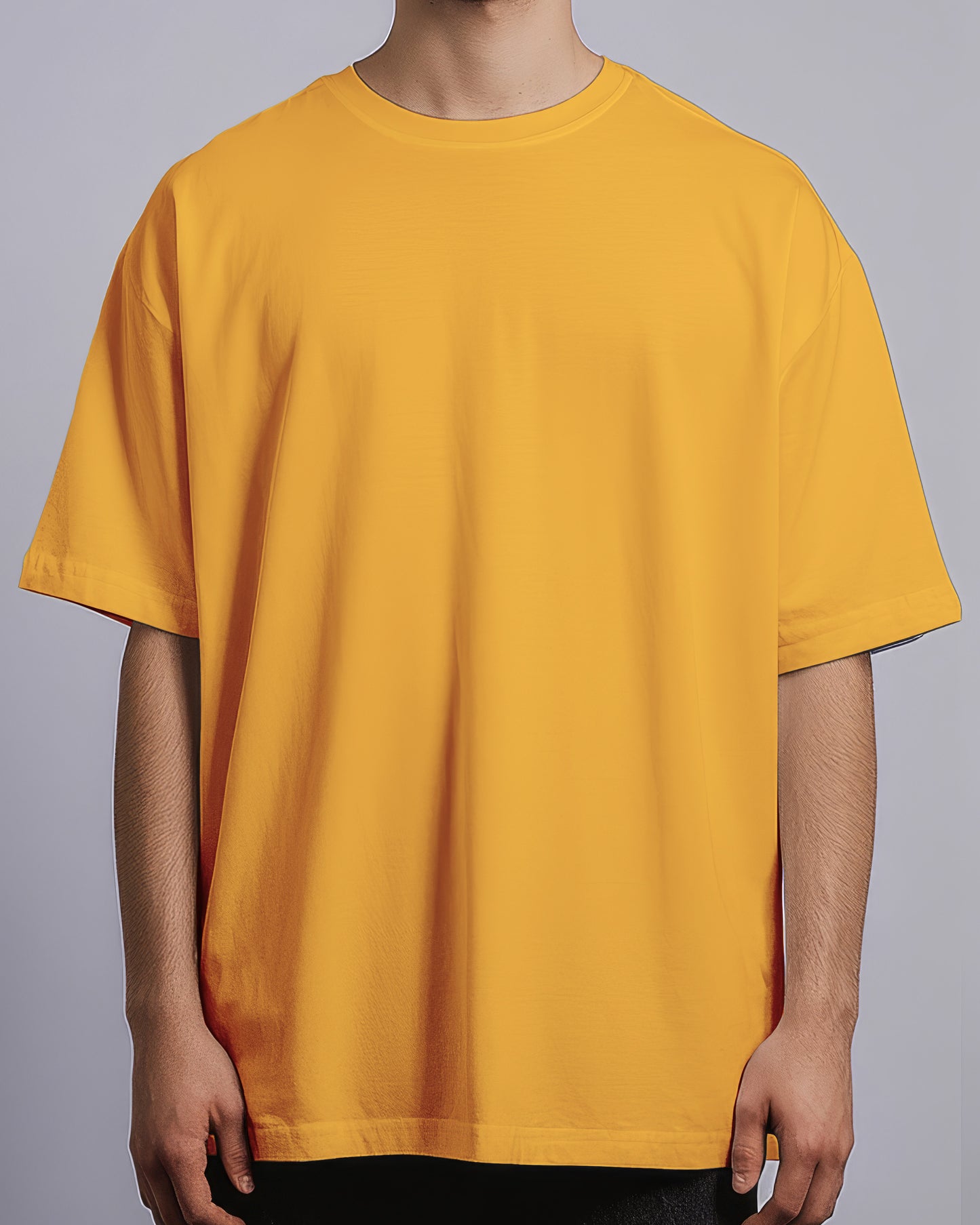 Yellow t-shirt worn by a person on a gray background